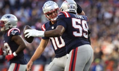 New England Patriots offensive tackle Vederian Lowe (59) is congratulated by quarterback Drake Maye after scoring a touchdown against the Los Angeles Rams during the second half of an NFL football game, Sunday, Nov. 17, 2024, in Foxborough, Mass. (AP Photo/Michael Dwyer)