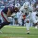 New England Patriots tight end Austin Hooper (81) runs for a touchdown as Miami Dolphins safety Jordan Poyer (21) defends during the second half of an NFL football game, Sunday, Nov. 24, 2024, in Miami Gardens, Fla. (AP Photo/Lynne Sladky)