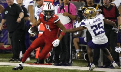 Arizona wide receiver Tetairoa McMillan (4 )runs away from Washington cornerback Elijah Jackson (25) during the first half of an NCAA college football game, Saturday, Sept. 30, 2023, in Tucson, Ariz. (AP Photo/Rick Scuteri)