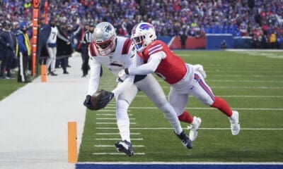 New England Patriots wide receiver Kayshon Boutte (9) scores a touchdown against Buffalo Bills cornerback Kaiir Elam (5) during the first quarter of an NFL football game, Sunday, Dec. 22, 2024, in Orchard Park, N.Y. (AP Photo/Gene J. Puskar)