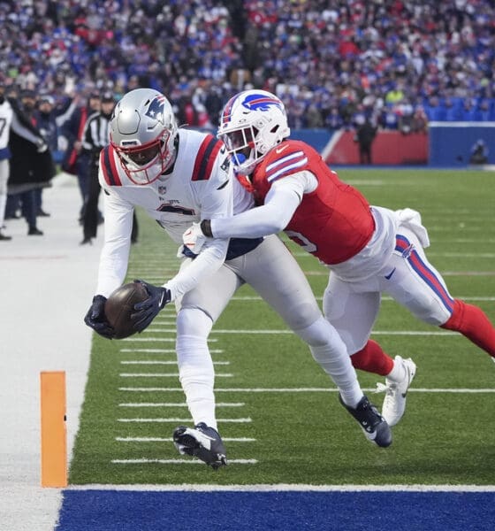 New England Patriots wide receiver Kayshon Boutte (9) scores a touchdown against Buffalo Bills cornerback Kaiir Elam (5) during the first quarter of an NFL football game, Sunday, Dec. 22, 2024, in Orchard Park, N.Y. (AP Photo/Gene J. Puskar)