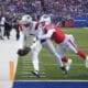 New England Patriots wide receiver Kayshon Boutte (9) scores a touchdown against Buffalo Bills cornerback Kaiir Elam (5) during the first quarter of an NFL football game, Sunday, Dec. 22, 2024, in Orchard Park, N.Y. (AP Photo/Gene J. Puskar)