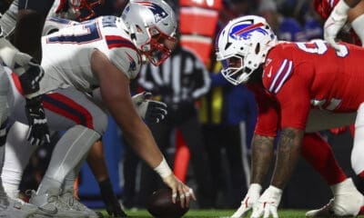 New England Patriots center Ben Brown (77) and Buffalo Bills defensive tackle DaQuan Jones (92) line up on the line of scrimmage during the first half of an NFL football game in Orchard Park, N.Y., Sunday Dec. 22, 2024. (AP Photo/ Jeffrey T. Barnes)