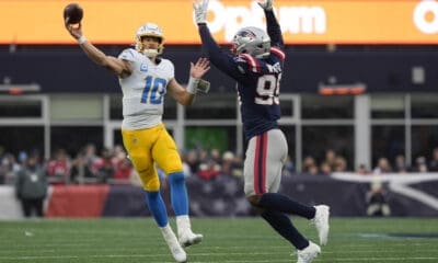 Los Angeles Chargers quarterback Justin Herbert (10) throws a pass while being chased by the New England Patriots Keion White (99) during the second half of an NFL football game, Saturday, Dec. 28, 2024, in Foxborough, Mass. (AP Photo/Michael Dwyer)