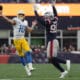 Los Angeles Chargers quarterback Justin Herbert (10) throws a pass while being chased by the New England Patriots Keion White (99) during the second half of an NFL football game, Saturday, Dec. 28, 2024, in Foxborough, Mass. (AP Photo/Michael Dwyer)