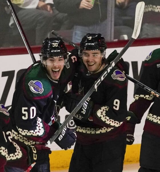 Arizona Coyotes' Sean Duran (50) and Clayton Keller (9) celebrate a power play open-net goal against the Pittsburgh Penguins' during the third period of an NHL hockey game Monday, Jan. 22, 2024, in Tempe, Ariz. (AP Photo/Darryl Webb)